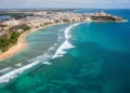 Aerial view of Puerto Rico coastline with turquoise water, Old San Juan colorful buildings.