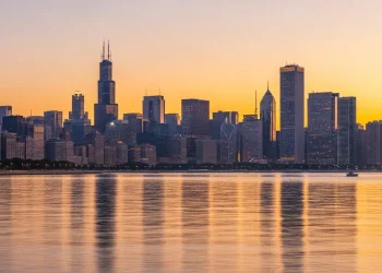 Chicago skyline at sunset with Lake Michigan, glowing golden sky, skyscrapers reflection, cinematic travel vibe, ultra realistic, 4K
